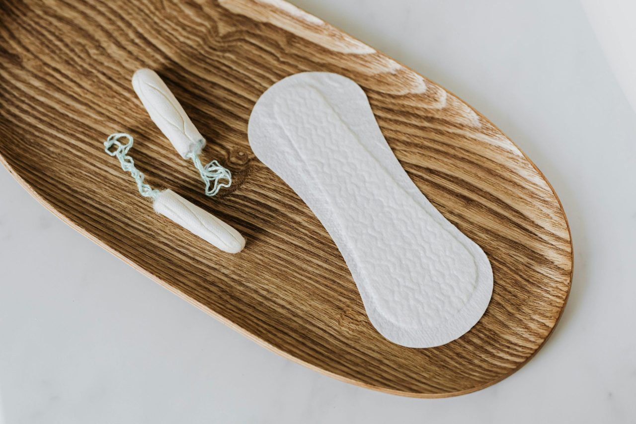 Tampons and period pads on a tray
